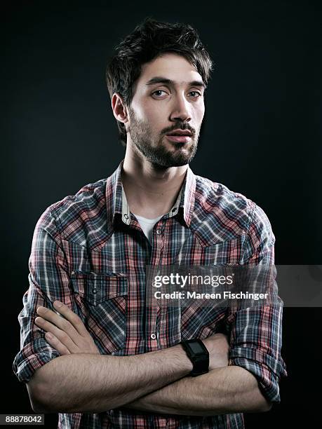 portrait of young man with plaid shirt - mareen fischinger stock pictures, royalty-free photos & images