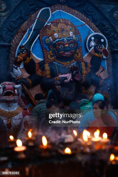 People offer butter light as they pray to the idol of god Kaal Bhairav at Kathmandu Darbar Square, a UNISCO World Heritage site in Kathmandu, Nepal,...