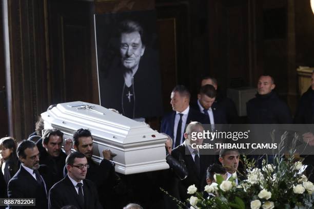 French singer Maxim Nucci aka Yodelice , manager Sebastien Farran along with relatives of late French singer Johnny Hallyday carry the coffin as they...