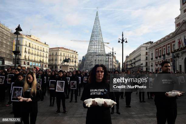 An activist of the 'IgualdadAnimal' organization holds a dead rabbit during a demonstration in support of animal rights at the Puerta del Sol Square...