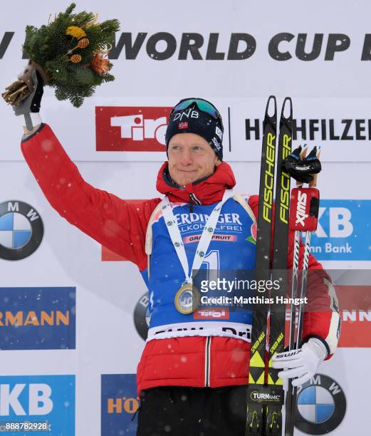 Johannes Thingnes Boe of Norway celebrates on the podium after the 12.5 km Men's Pursuit during the BMW IBU World Cup Biathlon on December 9, 2017 in...
