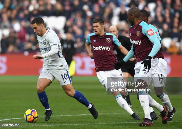 Eden Hazard of Chelsea gets away from Aaron Cresswell of West Ham United during the Premier League match between West Ham United and Chelsea at...