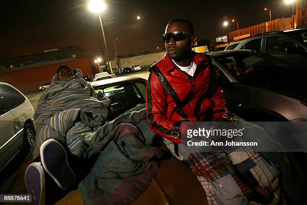 Brothers Otis Collins and Anthony Collins from Los Angeles, who slept on the roof of their car watch as Asian elephants head to the Staples Center,...