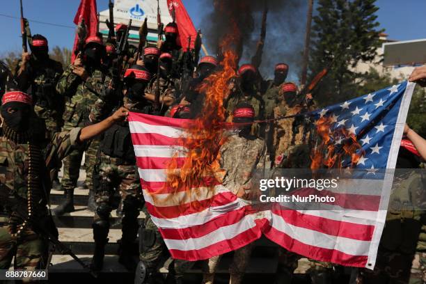 Palestinian militants of the National Resistance brigades, the armed wing of the Democratic Front for the Liberation of Palestine , burn US flag...