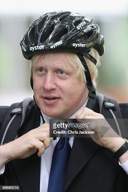 Mayor of London Boris Johnson gets on his bike as he leaves the unveiling of the July 7 bombings memorial service at Hyde Park on July 7, 2009 in...