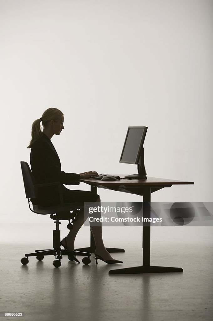 Woman at desk working on computer