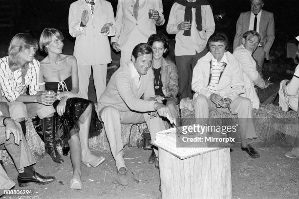 Roger Moore's 50th Birthday Party in the bush near Tshipise, South Africa, during the filming of his latest film 'Wild Geese.' Roger is pictured with...