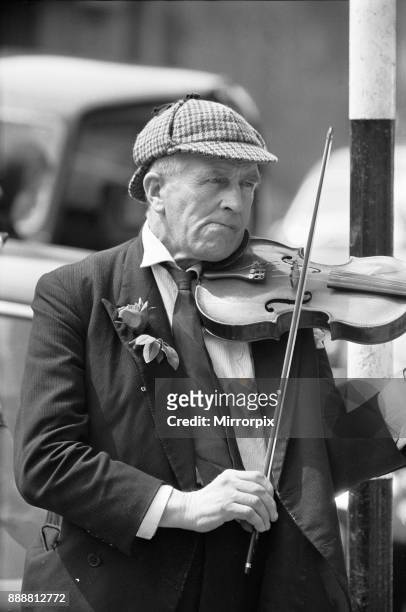 Elderly street musician performing on the streets of central London. Taken for the Daily Herald Faces of Britain series, 20th September 1963.