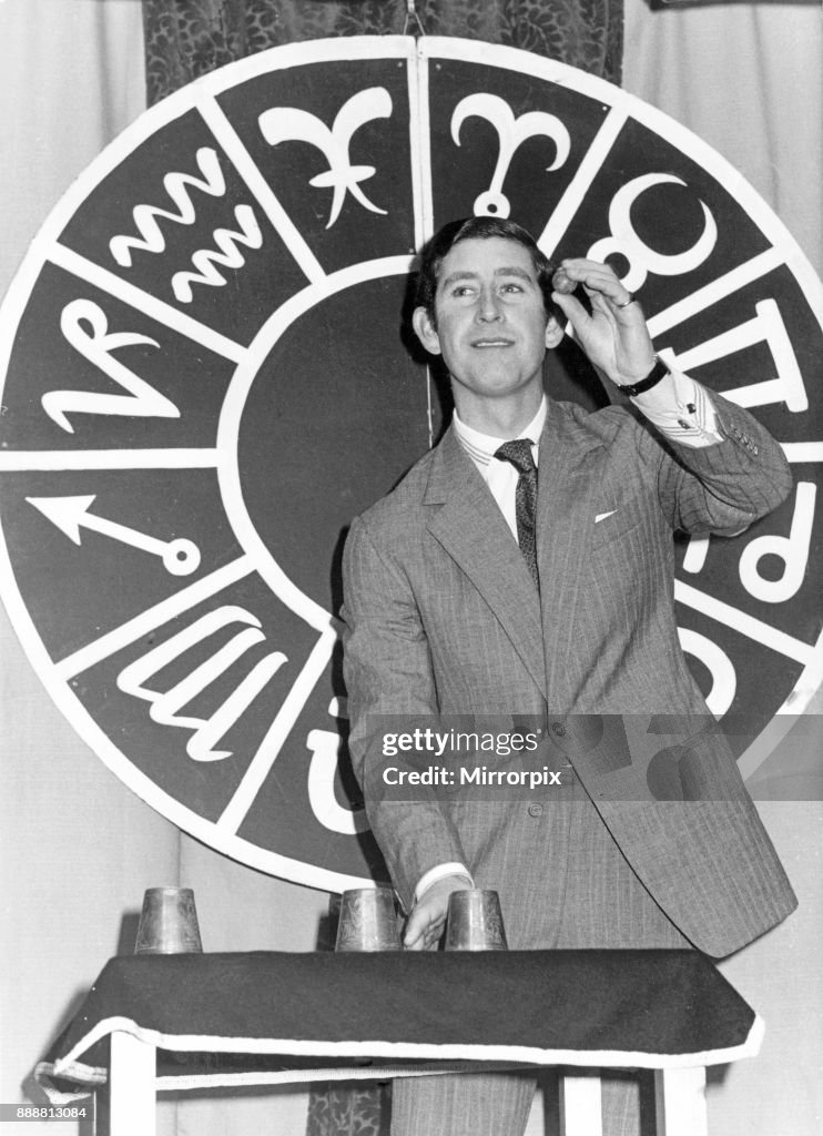 Prince Charles performs his first conjuring trick in public to gain his membership to the Magic Circle