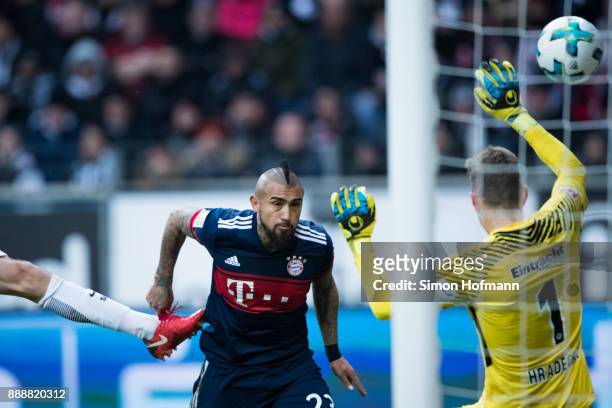 Arturo Vidal of Muenchen scores his team's first goal with a header past goalkeeper Lukas Hradecky of Frankfurt during the Bundesliga match between...