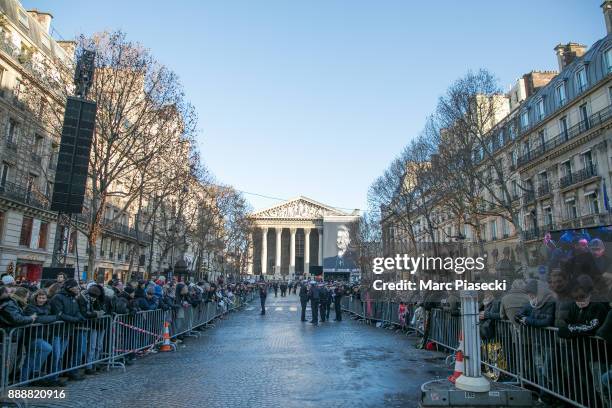 Fans gather on the Rue Royale during Johnny Hallyday's funeral at Eglise De La Madeleine on December 9, 2017 in Paris, France. France is paying...