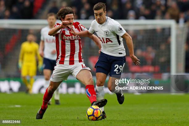 Tottenham Hotspur's English midfielder Harry Winks vies with Stoke City's Welsh midfielder Joe Allen during the English Premier League football match...