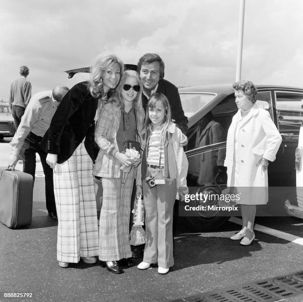 Des O'Connor with his wife Gillian and daughters Tracy and Samantha at the airport, 3rd August 1974.