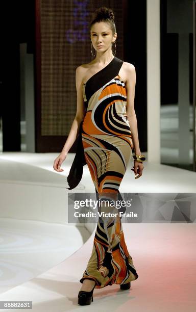 Model walks down the runway with a creation by Italian designer Espen Salberg at the 'Day & Night' show during the Hong Kong Fashion Week S/S 2010 on...