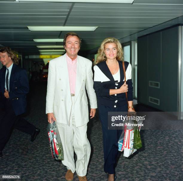 Des O'Connor and girlfriend Jodie Brooke Wilson and Heathrow Airport, 30th August 1992.