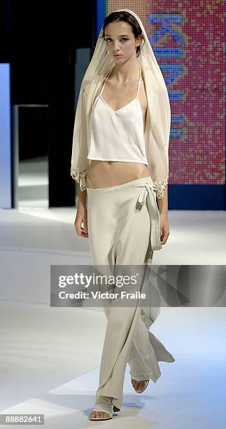 Model walks down the runway with a creation by Japanese designer Kinji at the 'Zen' show during the Hong Kong Fashion Week S/S 2010 on July 7, 2009...