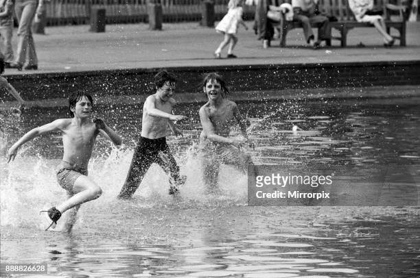 Well into the 80s - today's sun brought out people onto Hampstead Heath to cool off in the water, 8th May 1976.