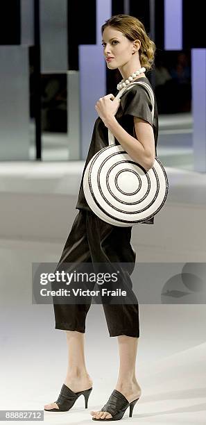 Model walks down the runway with a creation by Japanese designer Kinji at the 'Zen' show during the Hong Kong Fashion Week S/S 2010 on July 7, 2009...