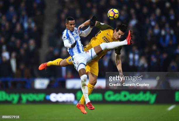Tom Ince of Huddersfield Town and Lewis Dunk of Brighton and Hove Albion compete to win a header during the Premier League match between Huddersfield...