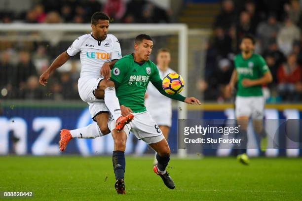 Wayne Routledge of Swansea City challenges Jake Livermore of West Bromwich Albion during the Premier League match between Swansea City and West...