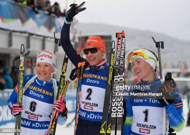 Kaisa Makarainen of Finland celebrates second place, Anastasiya Kuzmina of Slovakia celebrates first place and Darya Domracheva of Belarus celebrates...