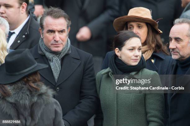 Jean Dujardin and Nathalie Pechalat leave the church after Johnny Hallyday's Funeral at Eglise De La Madeleine on December 9, 2017 in Paris, France....