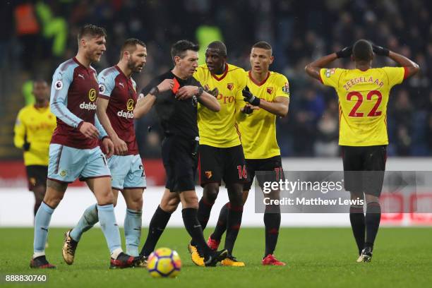 Marvin Zeegelaar of Watford reacts to being shown a red card by referee Lee Probert during the Premier League match between Burnley and Watford at...