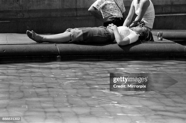 The temperatures rose again today in London and pavements became hotter and hotter. A woman relaxes in the sunshine in Trafalgar Square, 24th June...