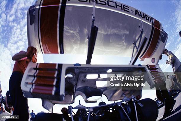 Mechanics lift engine cowling for the Porsche 917/10 in the pits at Donnybrooke Raceway during qualifying for the Can Am race to be held September...