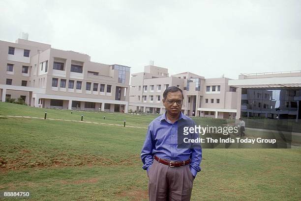 Narayana Murthy, Founder CEO of Infosys standing in the campus garden