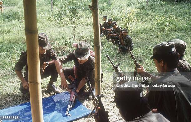 Militants are trained in the use of arms and ammunition at the training camp in the jungles of Assam