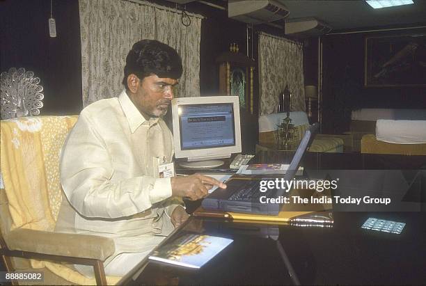 Nara Chandrababu Naidu, Chief Minister of Andhra Pradesh working with his laptop in his office