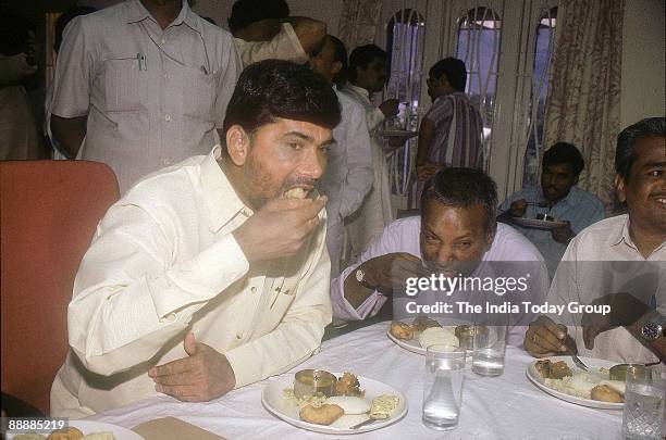 Nara Chandrababu Naidu, Chief Minister of Andhra Pradesh eating breakfast with others at a party function