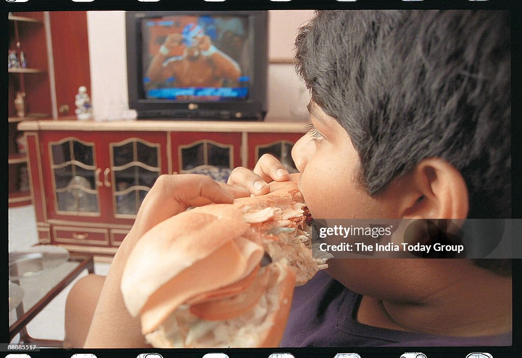 Boy eating Burger ( Obesity )-DIGICAM-IT USED 10/4/2006