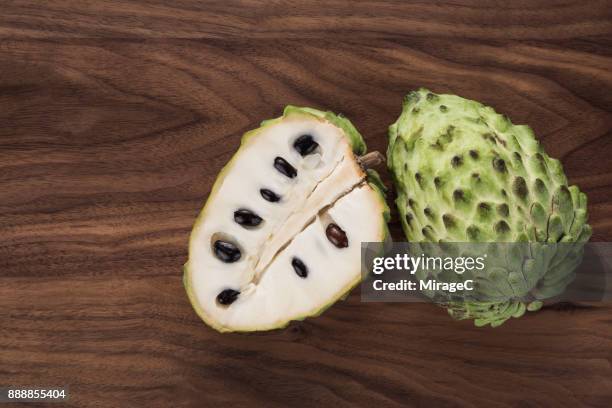 cherimoya on wood - annona cherimola stock pictures, royalty-free photos & images