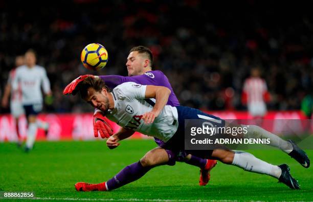 Stoke City's English goalkeeper Jack Butland manages to prevent Tottenham Hotspur's English striker Harry Kane scoring during the English Premier...