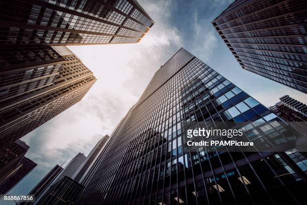 manhattan skyscapers wall street financial district new york city - wall street lower manhattan stock pictures, royalty-free photos & images
