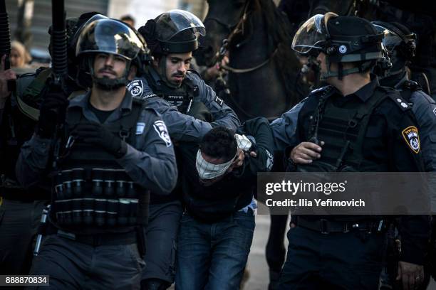 Israeli police forces arrest a Palestinian protester on December 9, 2017 in Jerusalem, Israel. Protest in Jerusalem, West Bank and Gaza continue into...