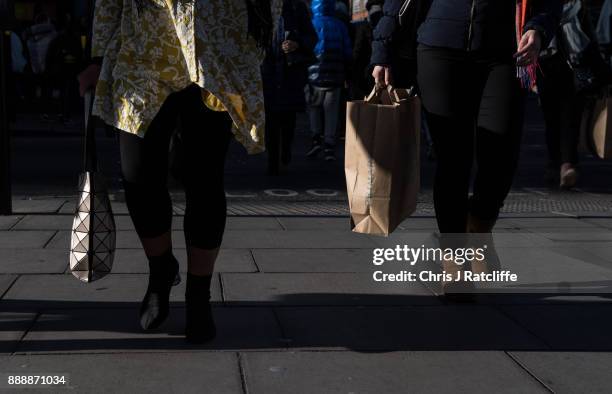 Shoppers walk down Oxford Street on December 9, 2017 in London, England. With two weeks of shopping time left before Christmas, high street retailers...