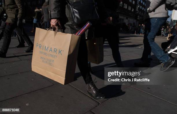 Shopper holds a Primark shopping bag on Oxford Street on December 9, 2017 in London, England. With two weeks of shopping time left before Christmas,...