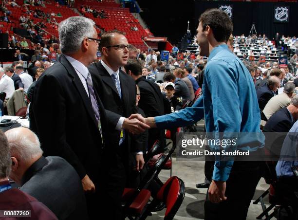 Jean-Francois Berube shakes the hand of a Los Angeles Kings Scout after being drafted during the second day of the 2009 NHL Entry Draft at the Bell...