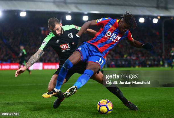 Wilfried Zaha of Crystal Palace battles for possesion with Steve Cook of AFC Bournemouth during the Premier League match between Crystal Palace and...