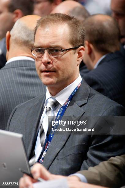 Head Coach Paul Maurice of the Carolina Hurricanes looks on from the Hurricanes draft table during the second day of the 2009 NHL Entry Draft at the...