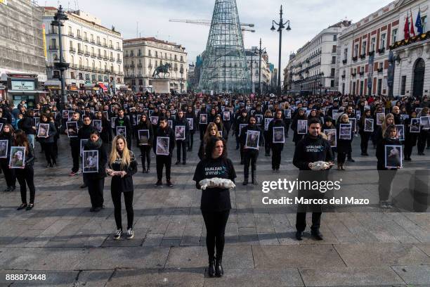 Hundreds of activists of pro-animal rights group 'Igualdad Animal' hold dead animals while others hold pictures of mistreated animals during a...