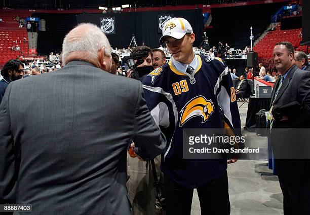 Marcus Foligno shakes the hand of a member of the Buffalo Sabres organization after being drafted during the second day of the 2009 NHL Entry Draft...