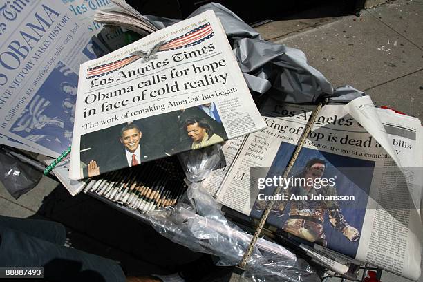 Vendor sells collectors newspapers with the inauguration of President Obama and the death of Michael Jackson on the covers outside the Michael...