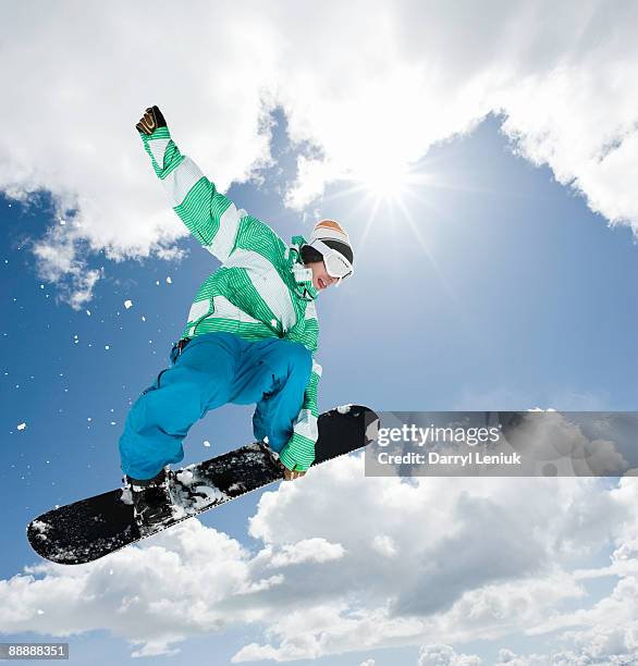 male snowboarder jumping in air - snowboarder stock pictures, royalty-free photos & images