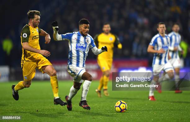 Elias Kachunga of Huddersfield Town is challenged by Dale Stephens of Brighton and Hove Albion during the Premier League match between Huddersfield...