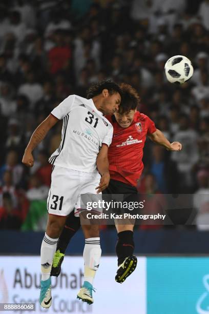 Tomoya Ugajin of Urawa reds compete for the header with Romarinho of Al Jazira> on December 9, 2017 in Abu Dhabi, United Arab Emirates.