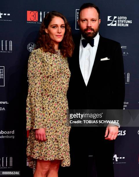 Greek director Yorgos Lanthimos and French actress Ariane Labed pose upon arrival for the 30th European Film Awards in Berlin, on December 9, 2017. /...